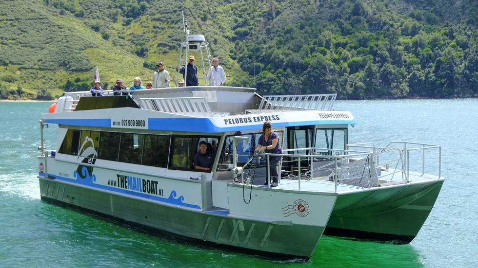 Boat coming up to a jetty on the Pelorus Mail Boat cruise.