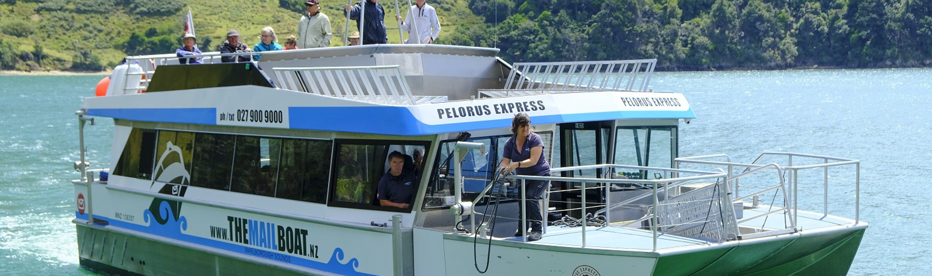 Boat coming up to a jetty on the Pelorus Mail Boat cruise.